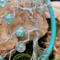 close up details show tree branches, trunk, and beads 